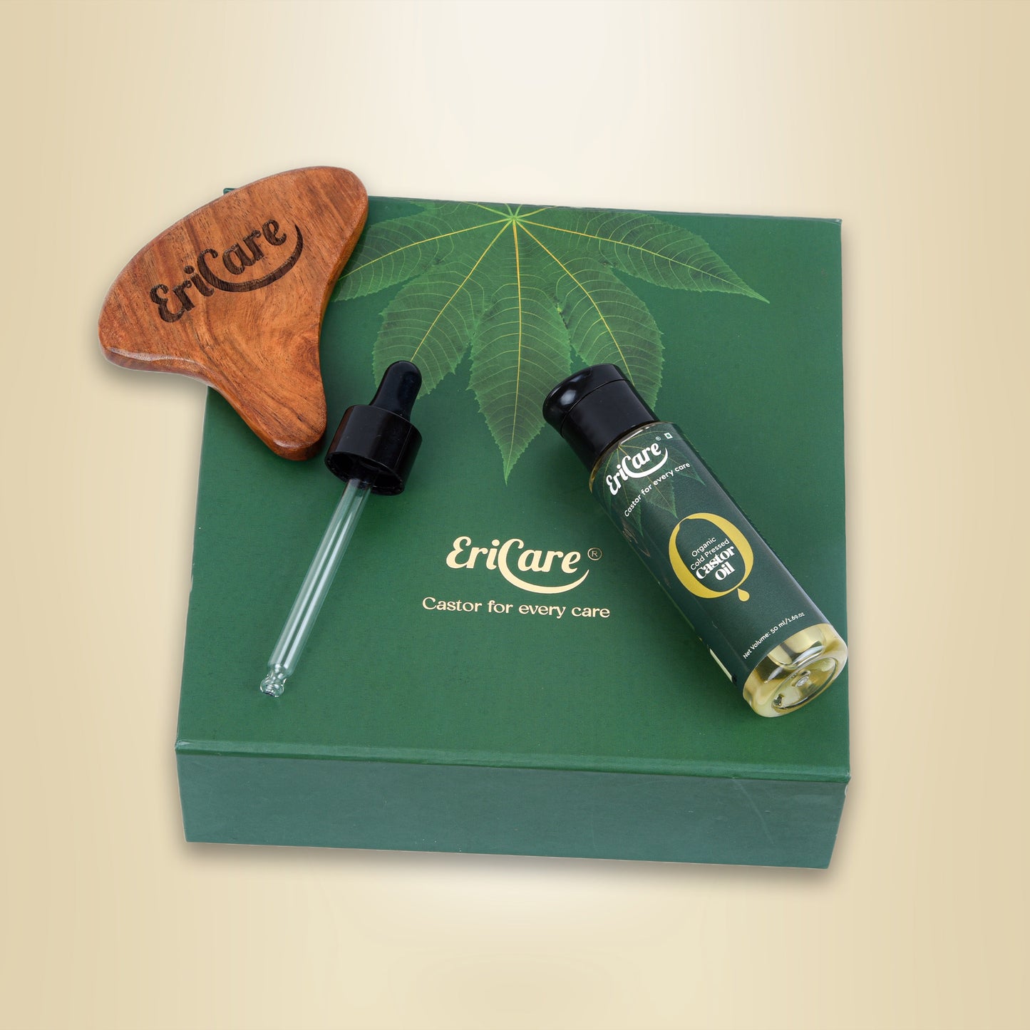 Top view of Castor oil care kit for skin that shows wooden Gua Sha Massager, Organic Castor Oil and Dropper