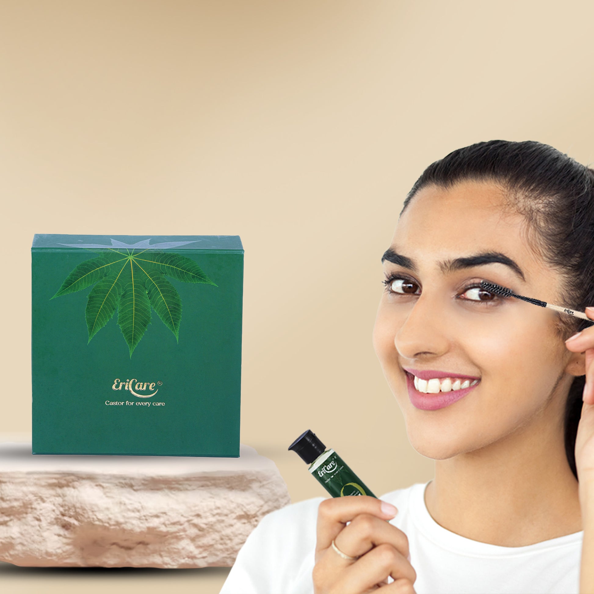 Woman cheerfully using a spoolie from the EriCare Castor Oil Kit for eyelashes growth